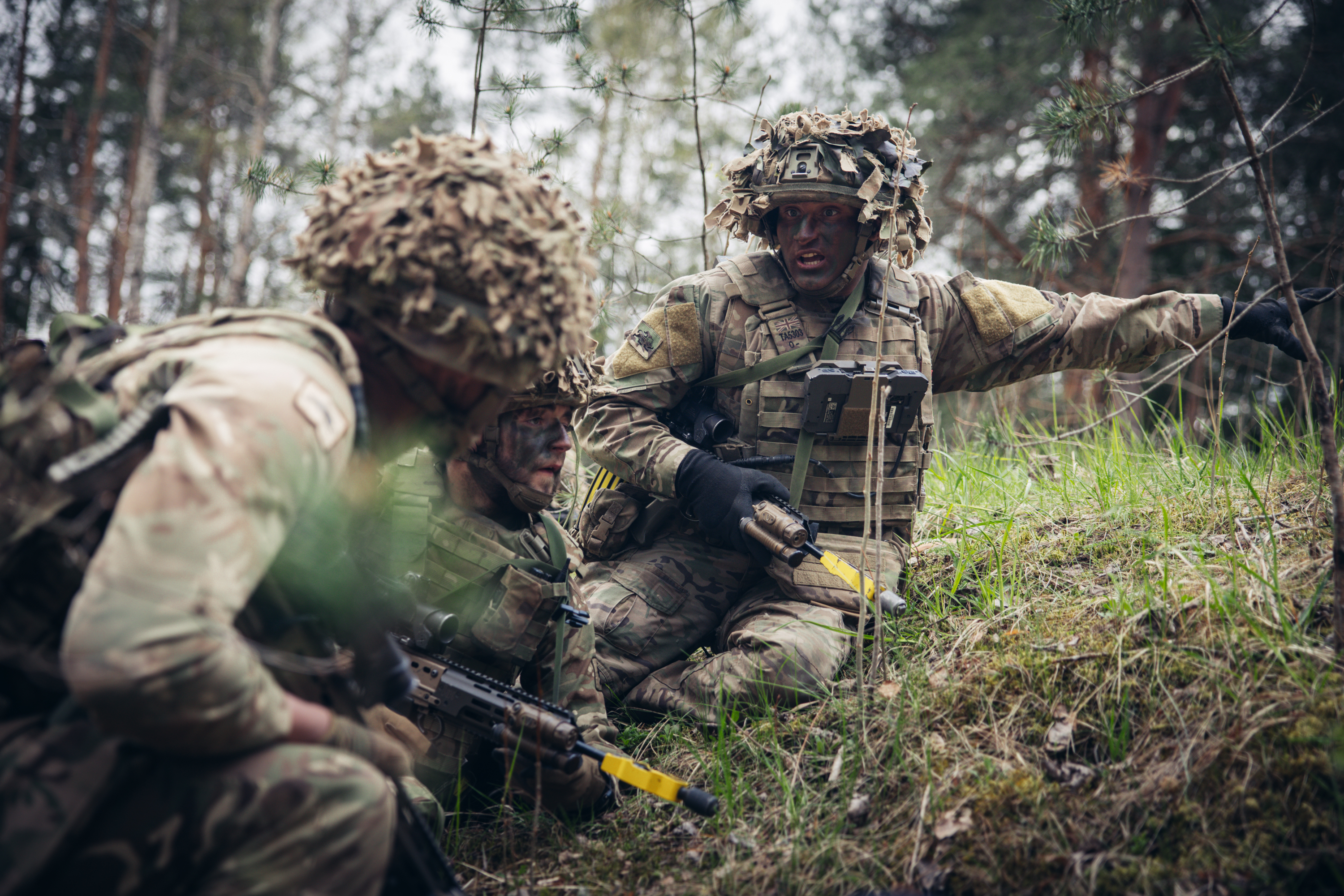 A soldier shouts commands to his section during an attack.