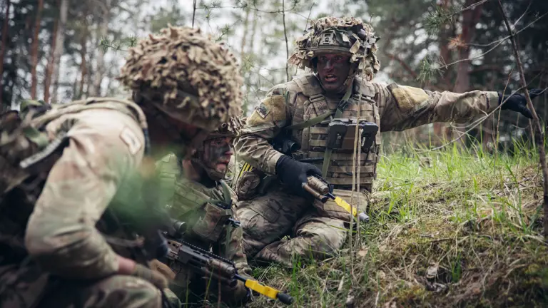 A soldier shouts commands to his section during an attack.