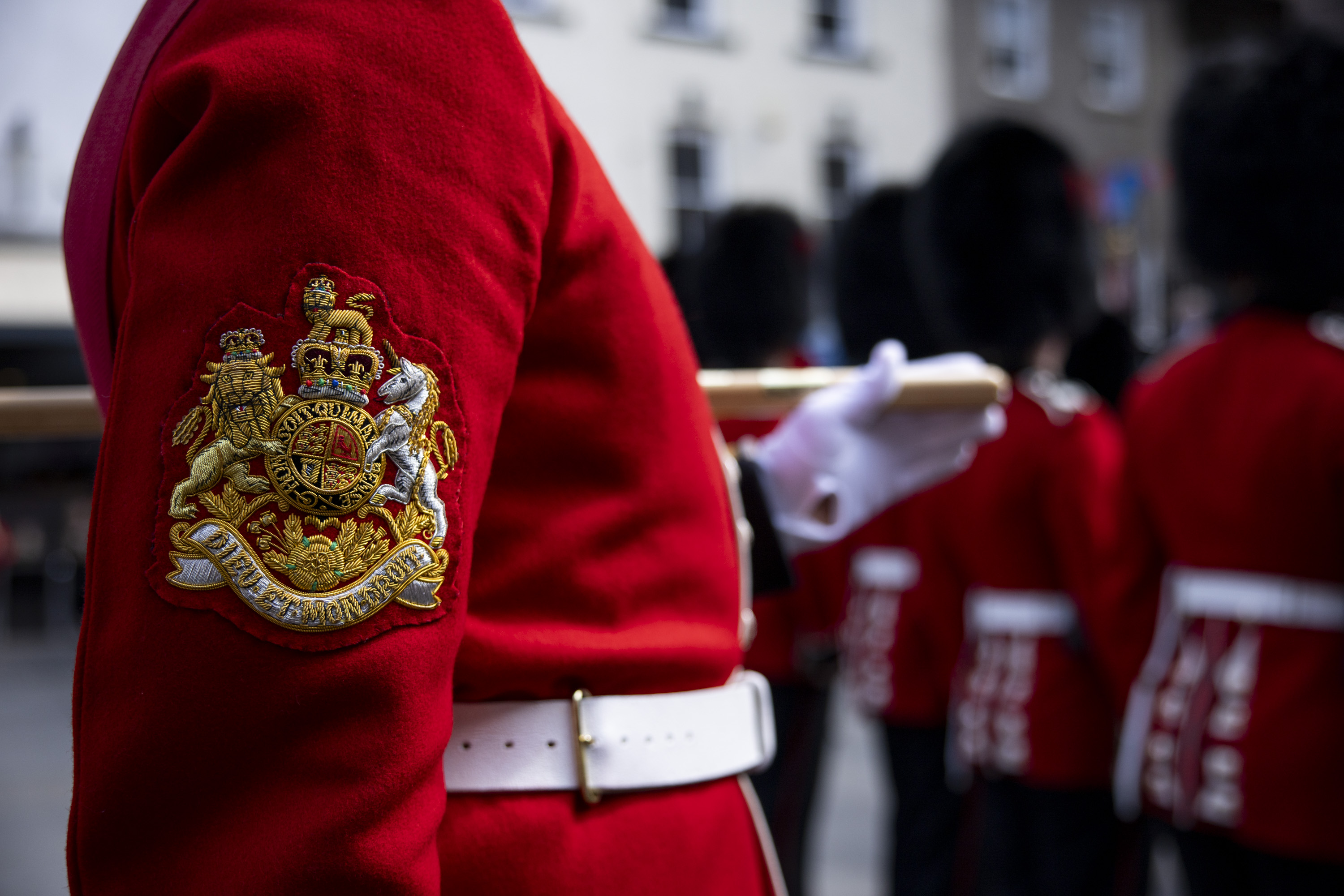 A ceremonial badge depicting the wearer's rank is worn on the arm of the soldier's red tunic.
