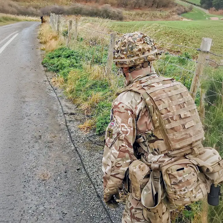 A high assurance search MWD is conducting a roadside search for an IED, it is on a 30meter line and has sat indicating that it has found something. The MWD will be recalled and the handler will indicate the find to the EOD operators.