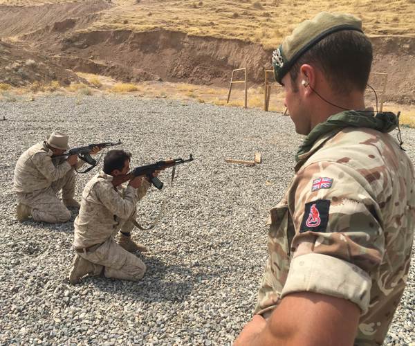 Menila-Cpl Mumby watching over Oil Protection Force soldiers firing on the range.jpg