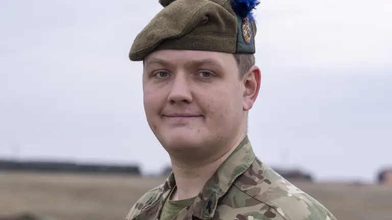 Pictured Reverend Daniel Alcock, 4th Battalion, The Royal Regiment of Scotland stood for a portrait in this camouflage uniform and beret in the field on exercise.