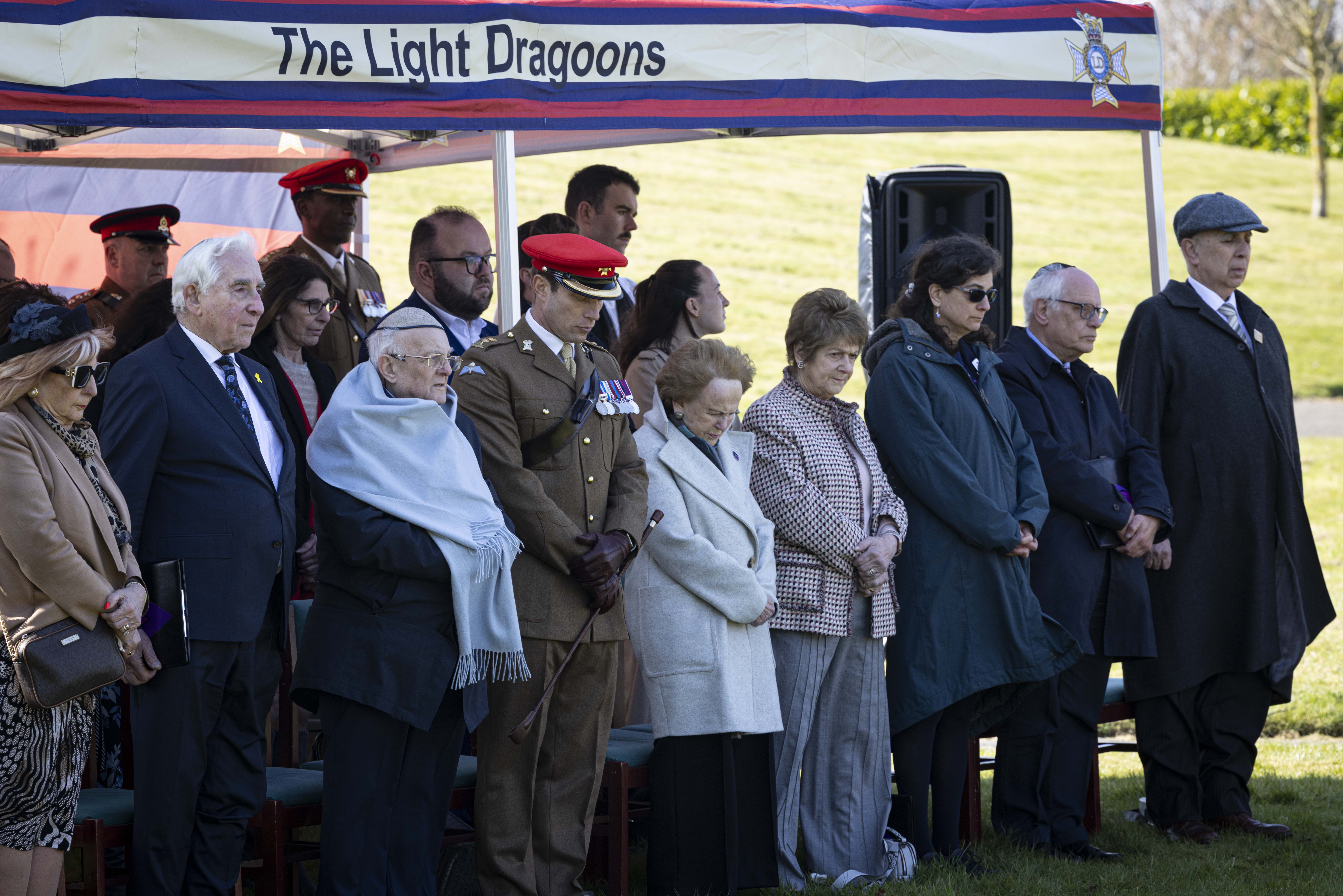 Members attending a special memorial service presented by The Light Dragoons stood under shelter paying their respects.  