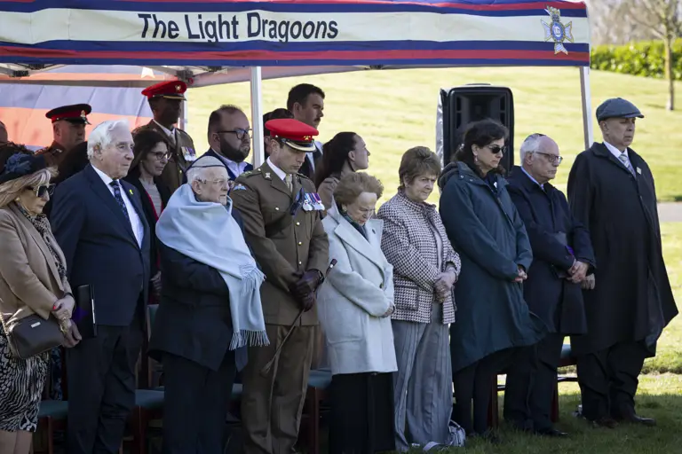 Members attending a special memorial service presented by The Light Dragoons stood under shelter paying their respects.