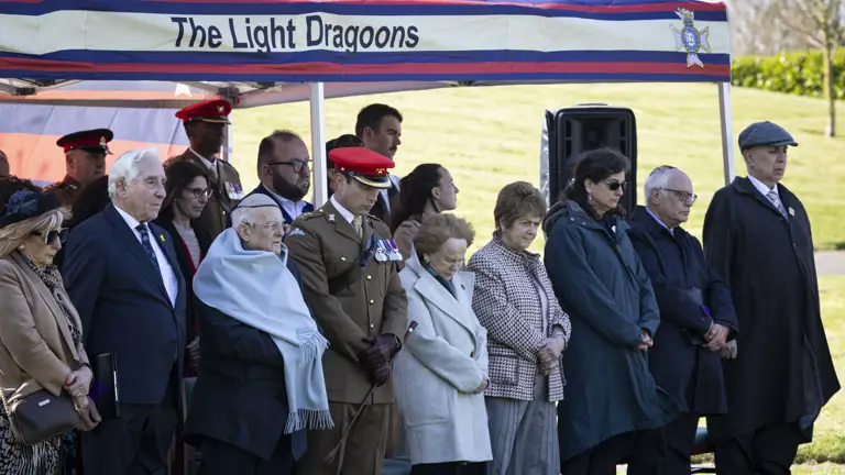 Members attending a special memorial service presented by The Light Dragoons stood under shelter paying their respects.