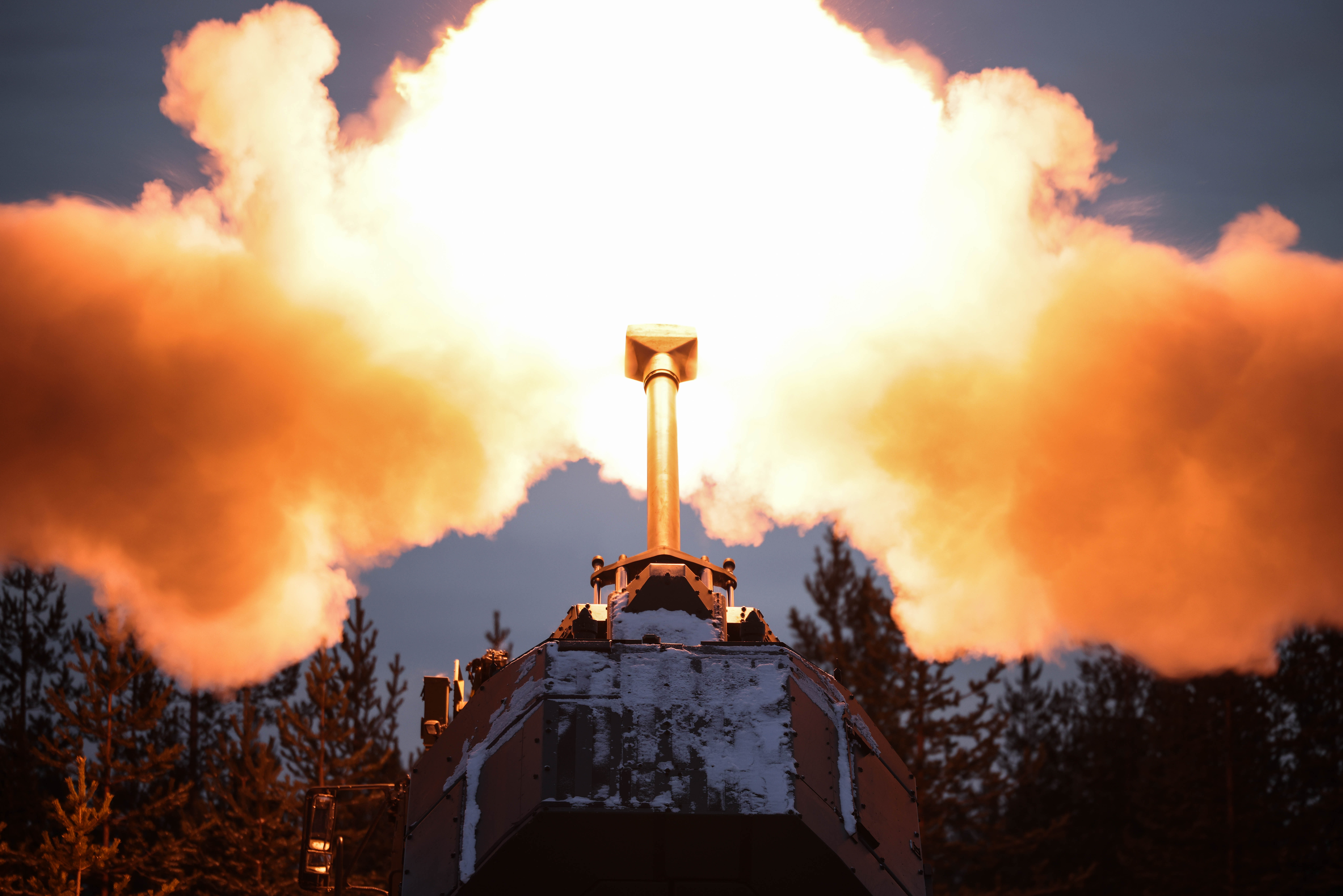 A close up of an artillery gun firing. 