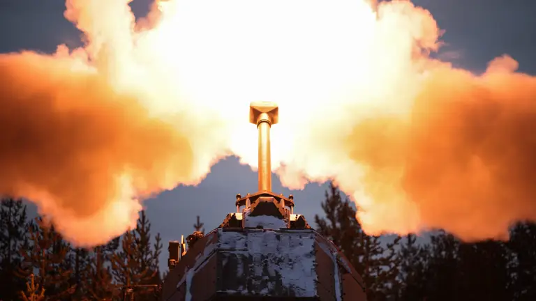 A close up of an artillery gun firing.