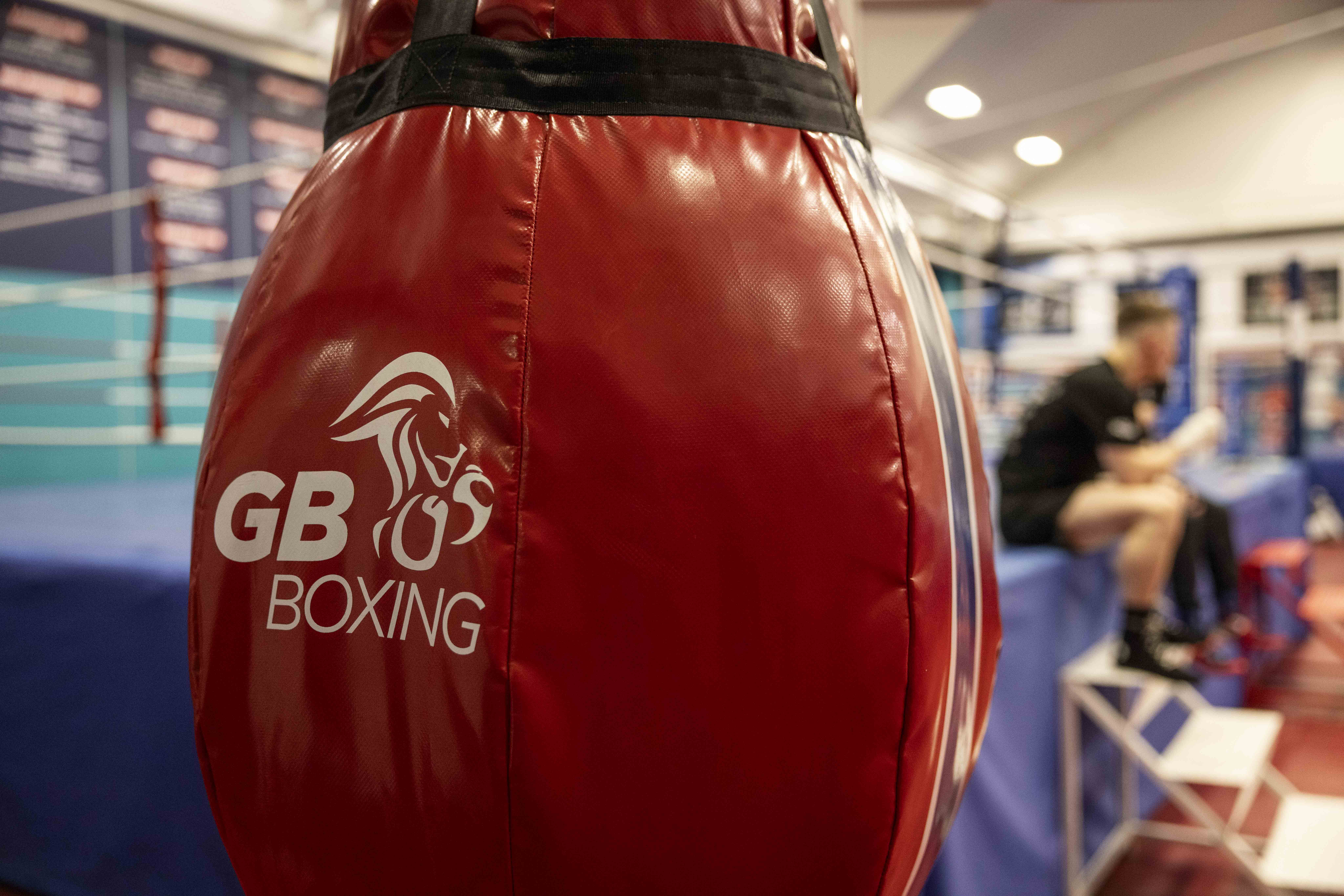 A red boxing bag shows a white lion and text that reads 'GB Boxing'.