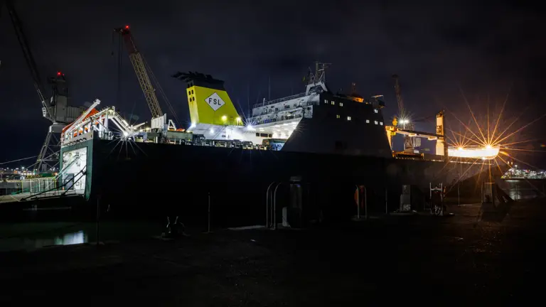 A large ship is pictured at night.