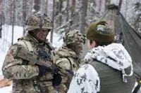 A military vehicle camouflaged with foliage traverses a snowy forest, surrounded by tall pine trees, creating a still, cold, and secretive atmosphere.