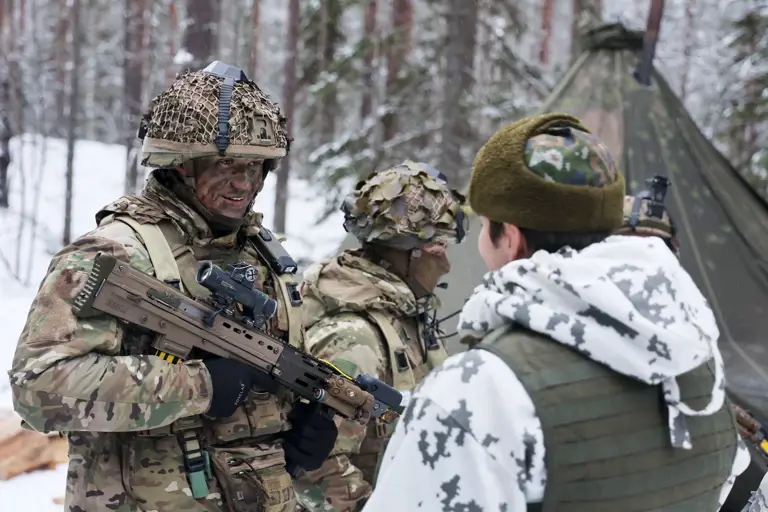 A military vehicle camouflaged with foliage traverses a snowy forest, surrounded by tall pine trees, creating a still, cold, and secretive atmosphere.