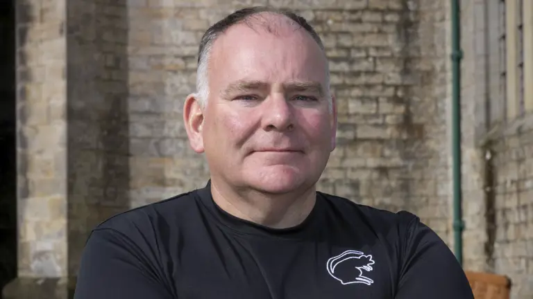 Portrait of a soldier seen in a plain top posing for a photo