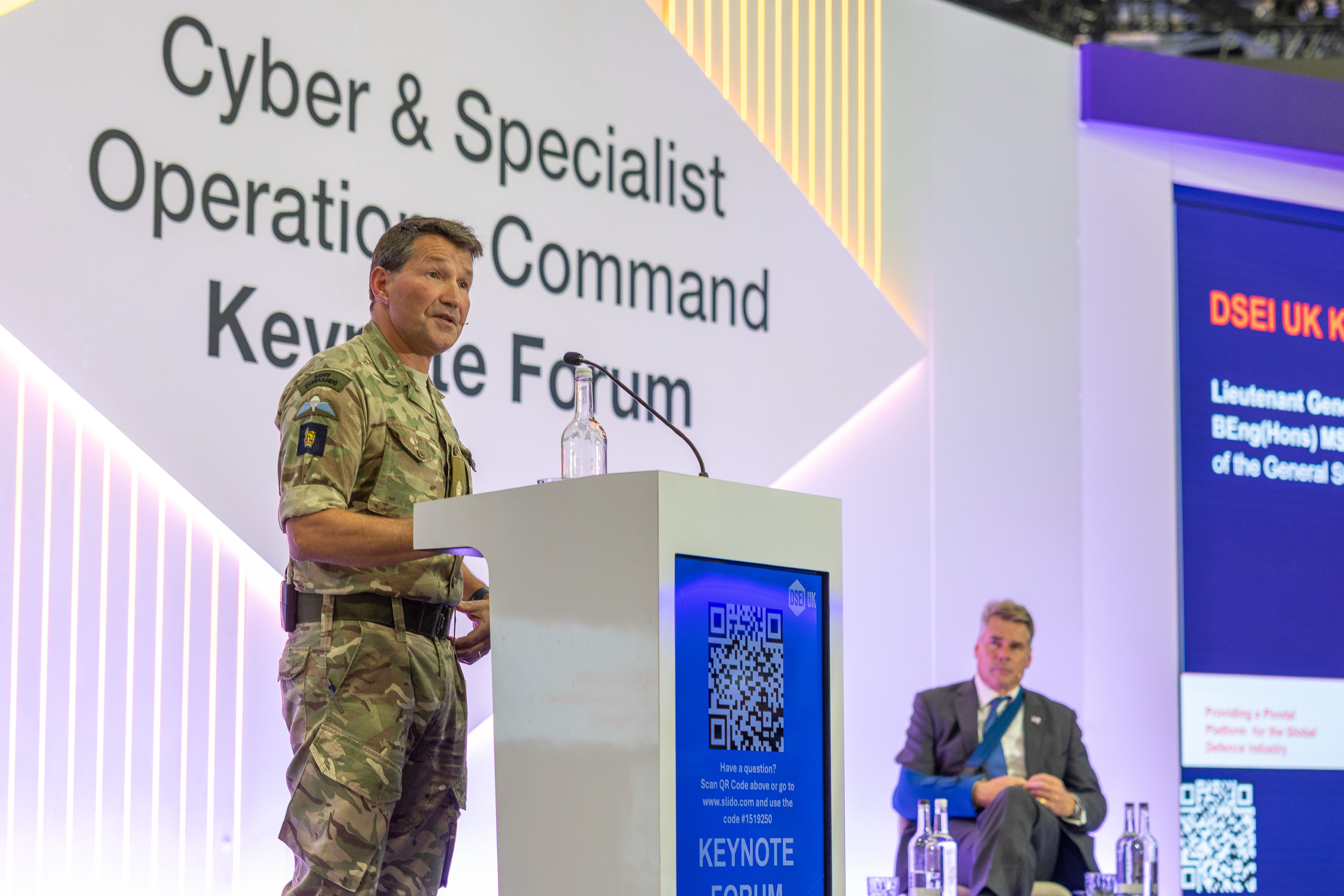 Military officer in uniform speaking at the Cyber & Specialist Operations Command Keynote Forum podium.