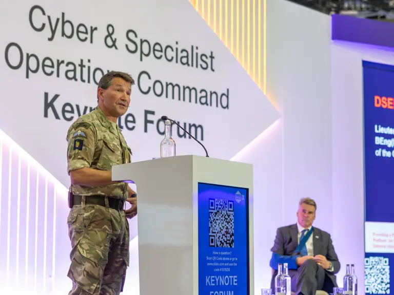 Military officer in uniform speaking at the Cyber & Specialist Operations Command Keynote Forum podium.