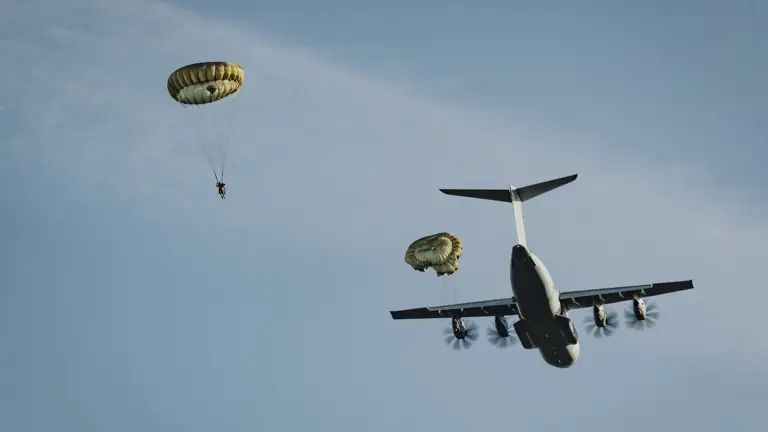 Two paratroopers are seen descending after jumping from a United States A400 aircraft