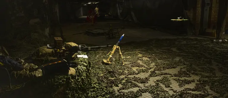 A drone is pictured flying through an artificially created war zone, mortar is located beneath the drone.