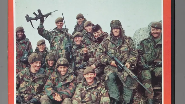 Soldier magazine cover image shower soldiers sat smiling together after the Falklands victory.