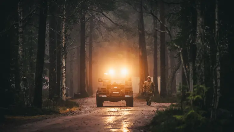A Material Handling Equipment Forklift drives across an icy vehicle park on Rovajärvi Training Area during Exercise Dynamic Front, Finland.