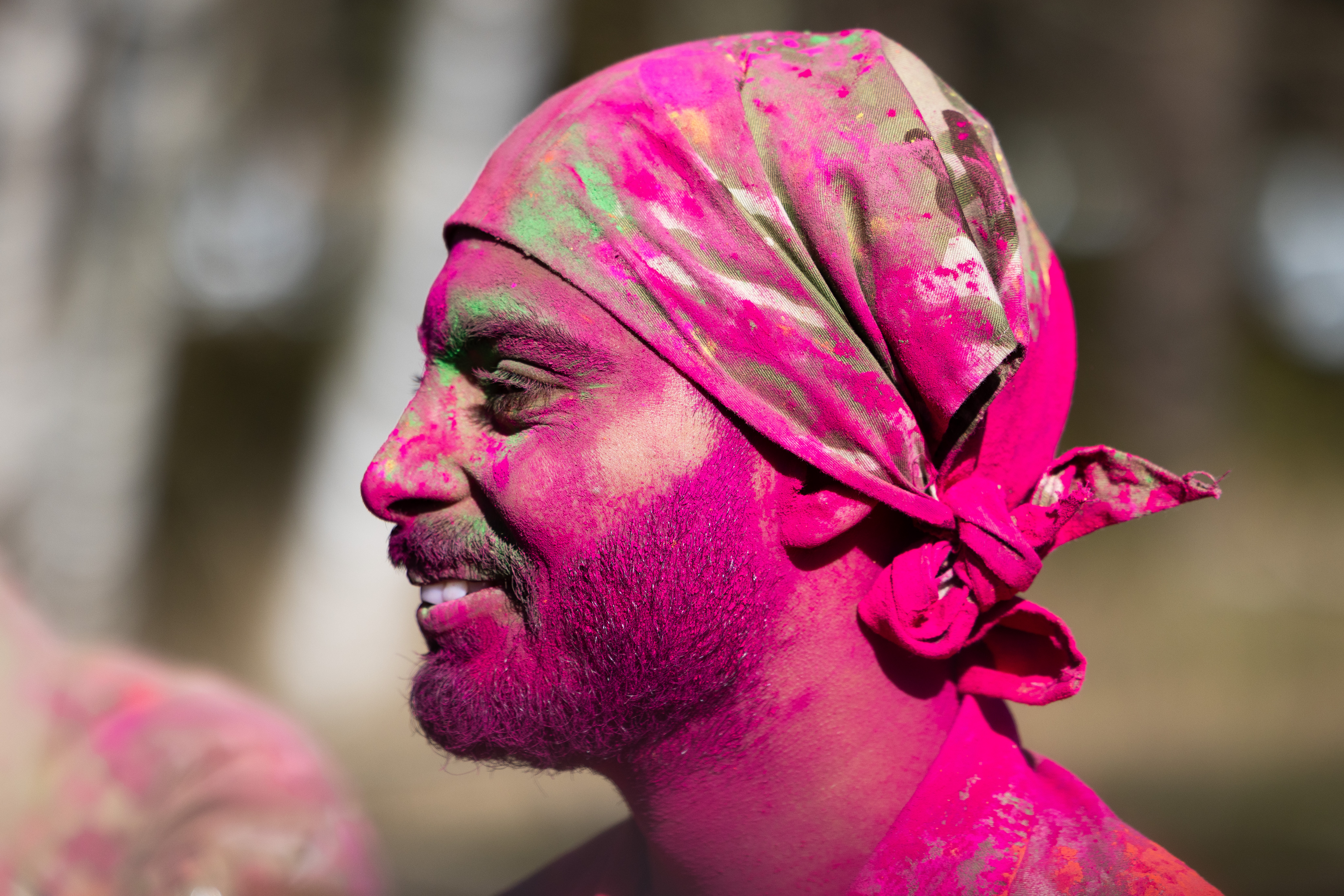 A close up of a Sikh British Army soldier covered in pink neon powder.