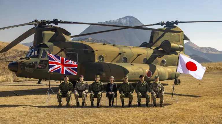 Group photo of distinguished guests (left to right) Major General Wakamatsu, 1st Airborne Brigade Commander; Brigadier Mark Berry, Commander of 16 Air Assault Brigade; General Morishita, Chief of Staff of Japanese Ground Self Defence Force; Julia Longbottom, UK Ambassador to Japan; Lieutenant General Togashi, Commander of Eastern Army; Major General Maejima, Commander of 12th Brigade; and Major Dan Ward, UK assistant defence attache in Japan. The Union Jack on the left and Japan's flag is on the right.