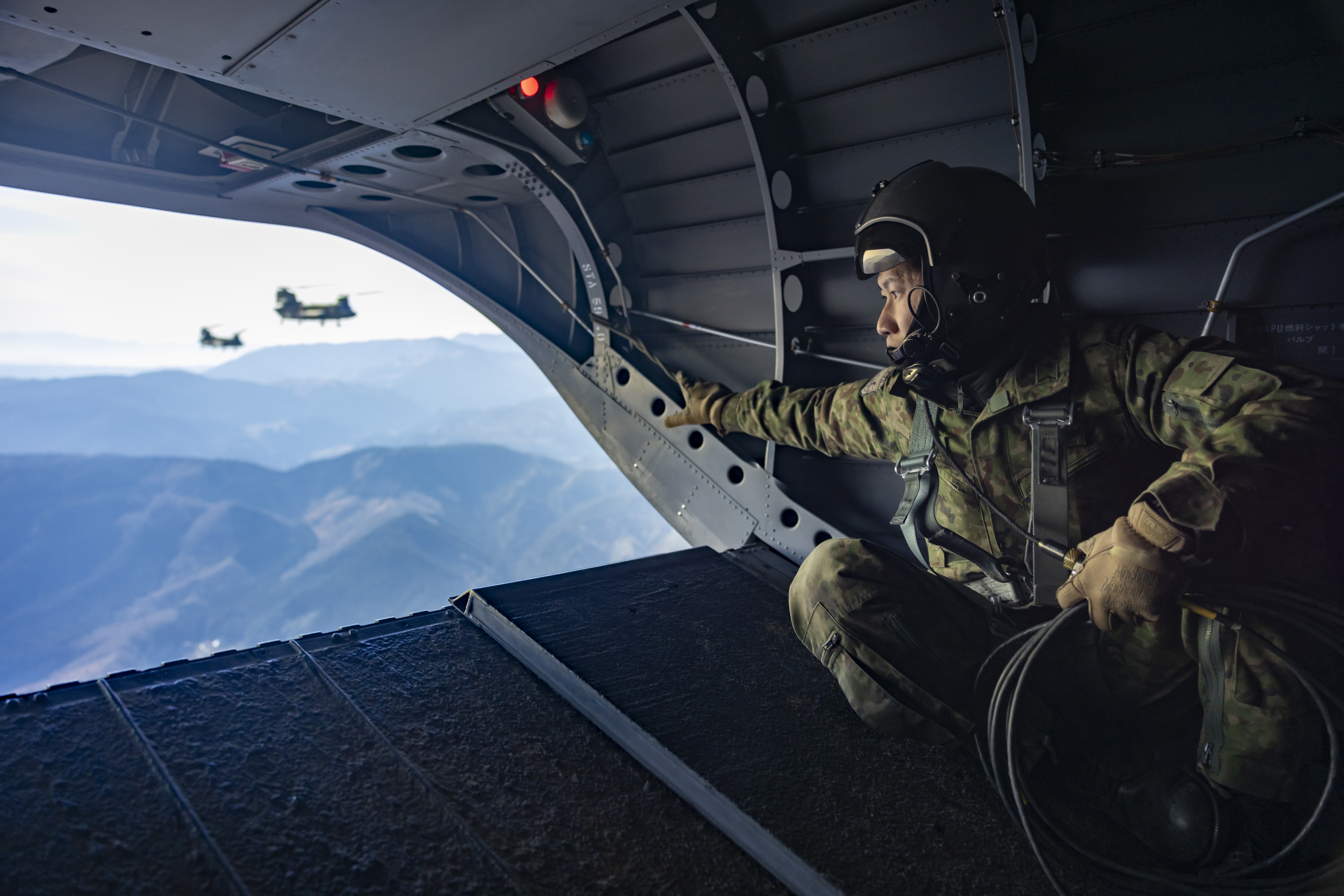 A Japanese soldier in camouflage uniform from the Japanese Ground Self Defence Forces’, looked out over the terrain as they transported paratroopers in three Japanese CH47’s as they begun their final tactical exercise in Japan 