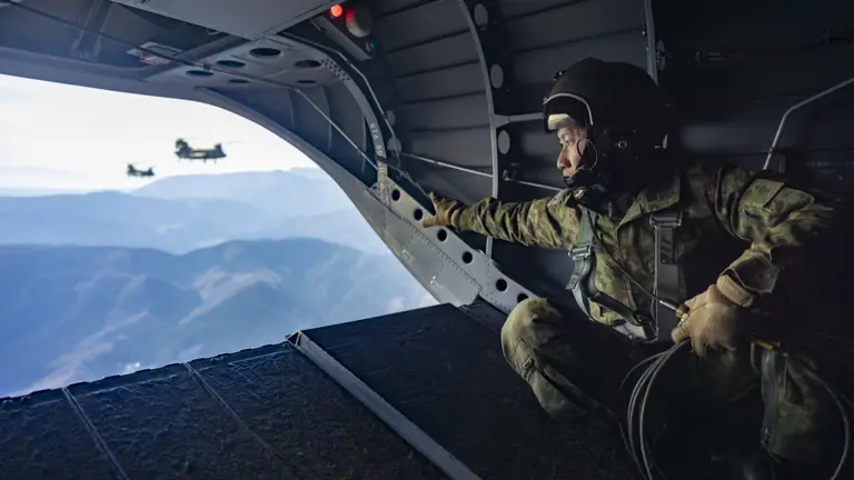A Japanese soldier in camouflage uniform from the Japanese Ground Self Defence Forces’, looked out over the terrain as they transported paratroopers in three Japanese CH47’s as they begun their final tactical exercise in Japan