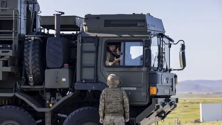 Pictured here is a soldier working on the Land Ceptor missile delivery vehicle with a driver talking to a soldier on the ground out the window of the vehicle.