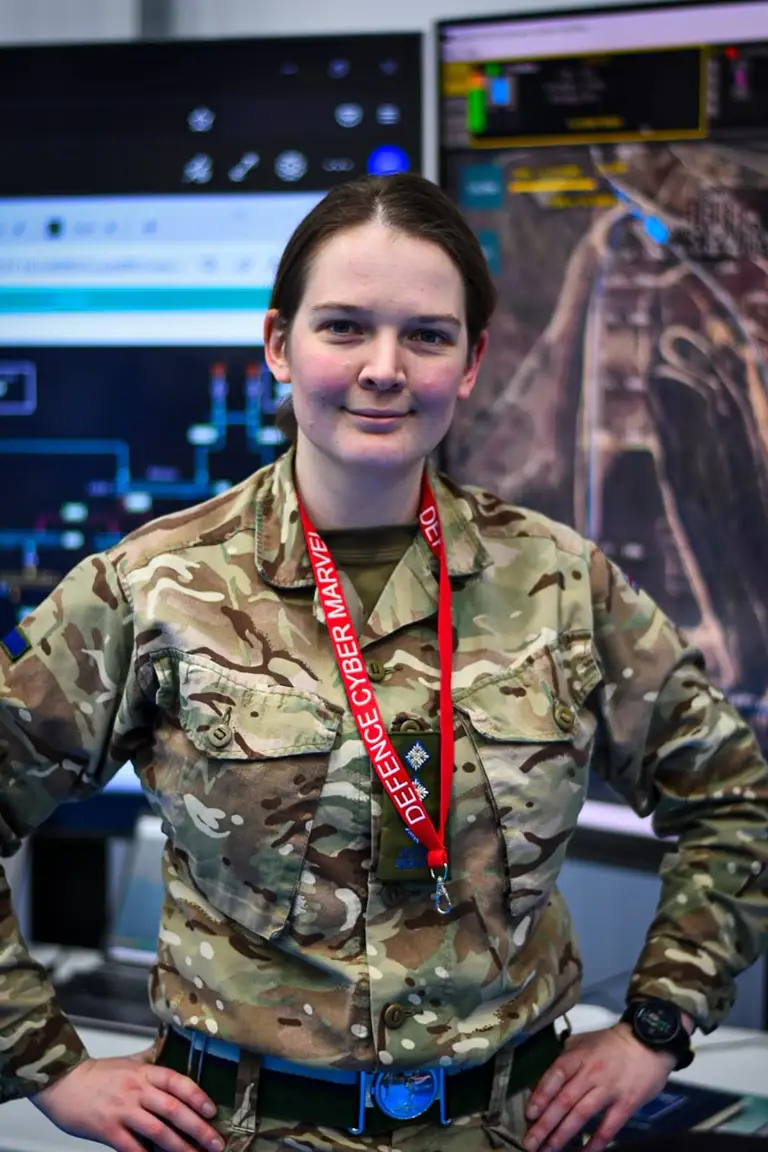 A lady in uniform is pictured with her hands on her hips.