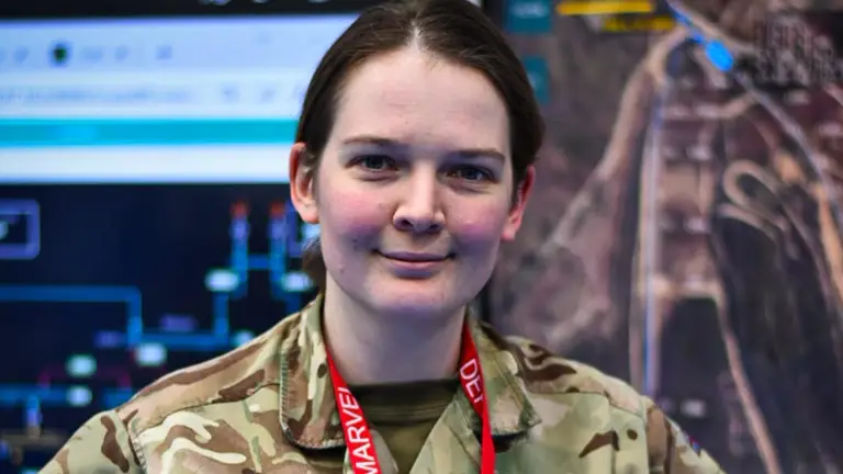 A lady in uniform is pictured with her hands on her hips.