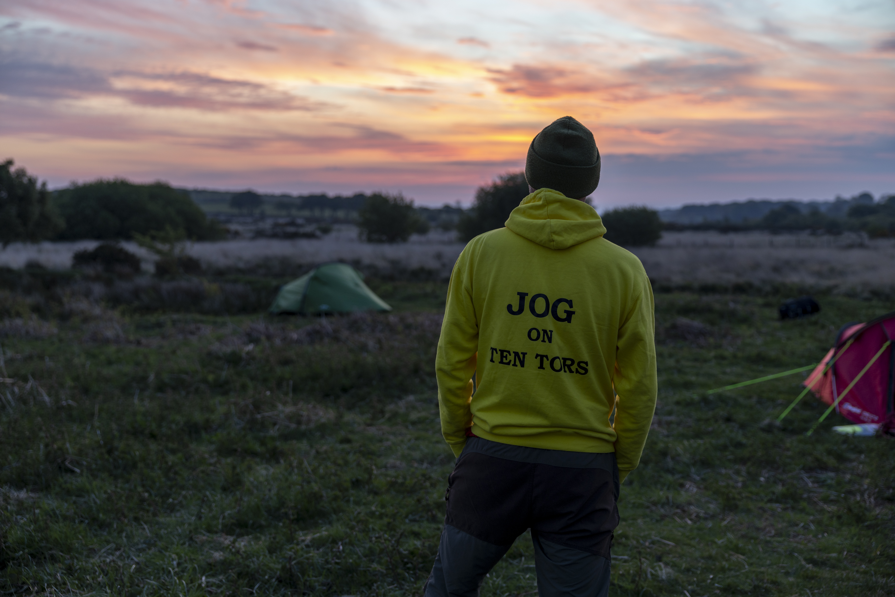 A person in a yellow hoodie with 