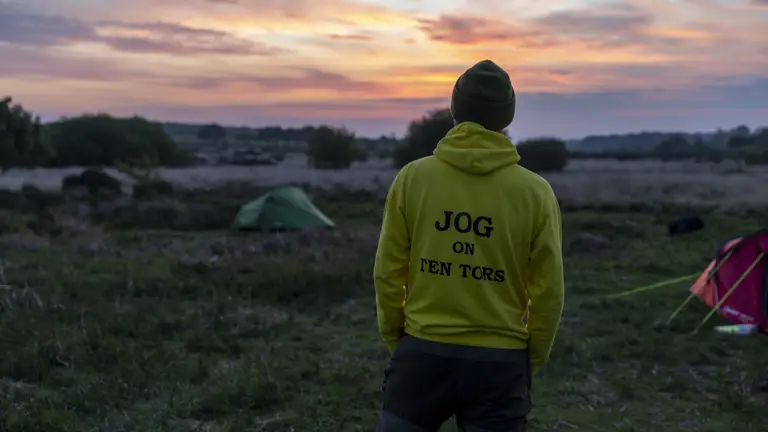 A person in a yellow hoodie with