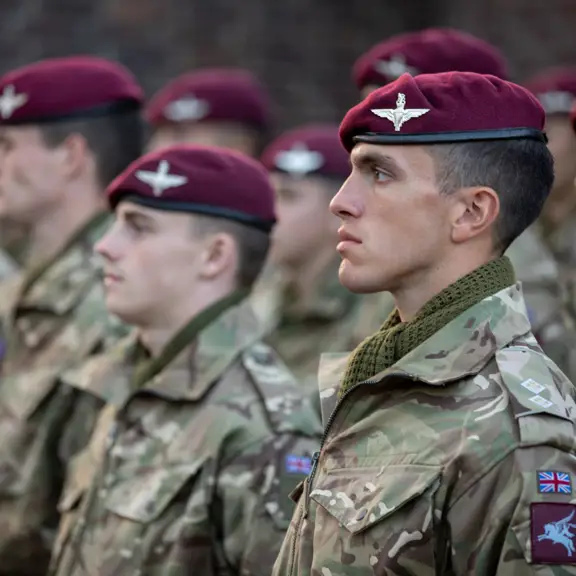 a line of soldiers with maroon berets