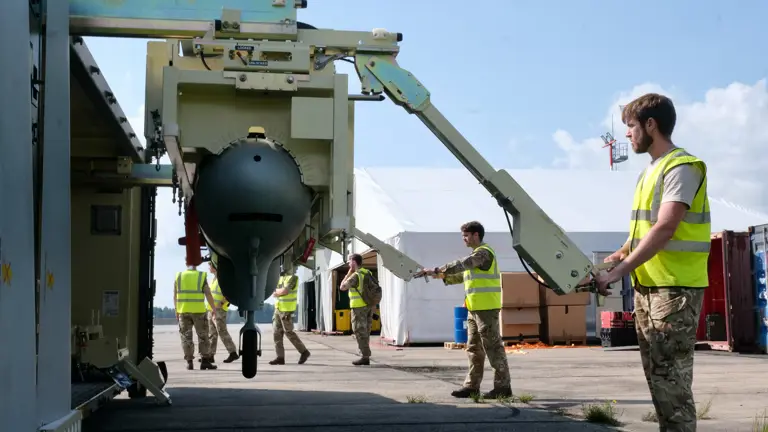 An unmanned aerial vehicle is removed from its transportation container.