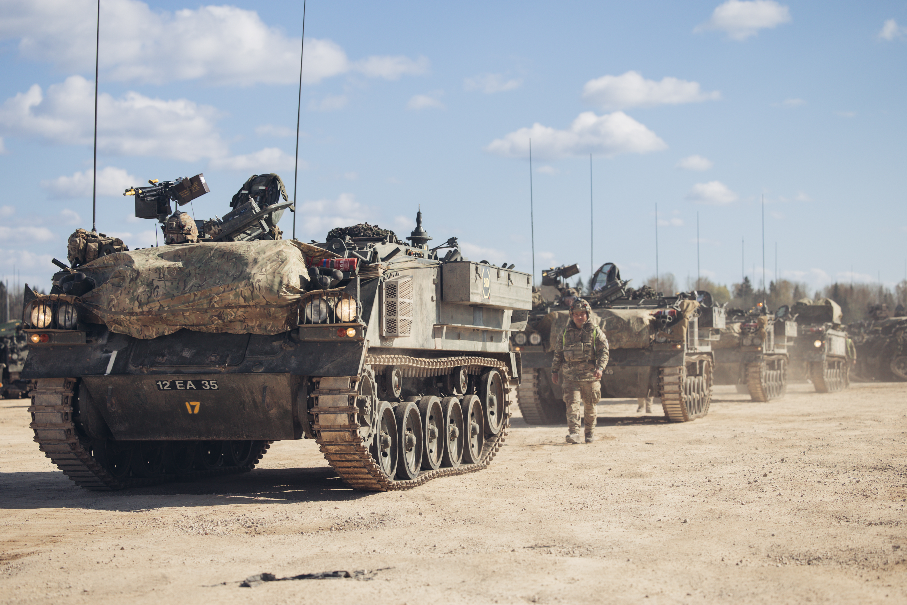 Warriors lined in into drill positions with soldiers to the side directing them. 