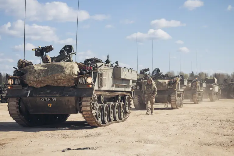 Warriors lined in into drill positions with soldiers to the side directing them. 