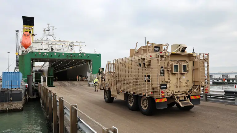 A Cyote vehicle is seen being driven onto the ship ready for transportation.