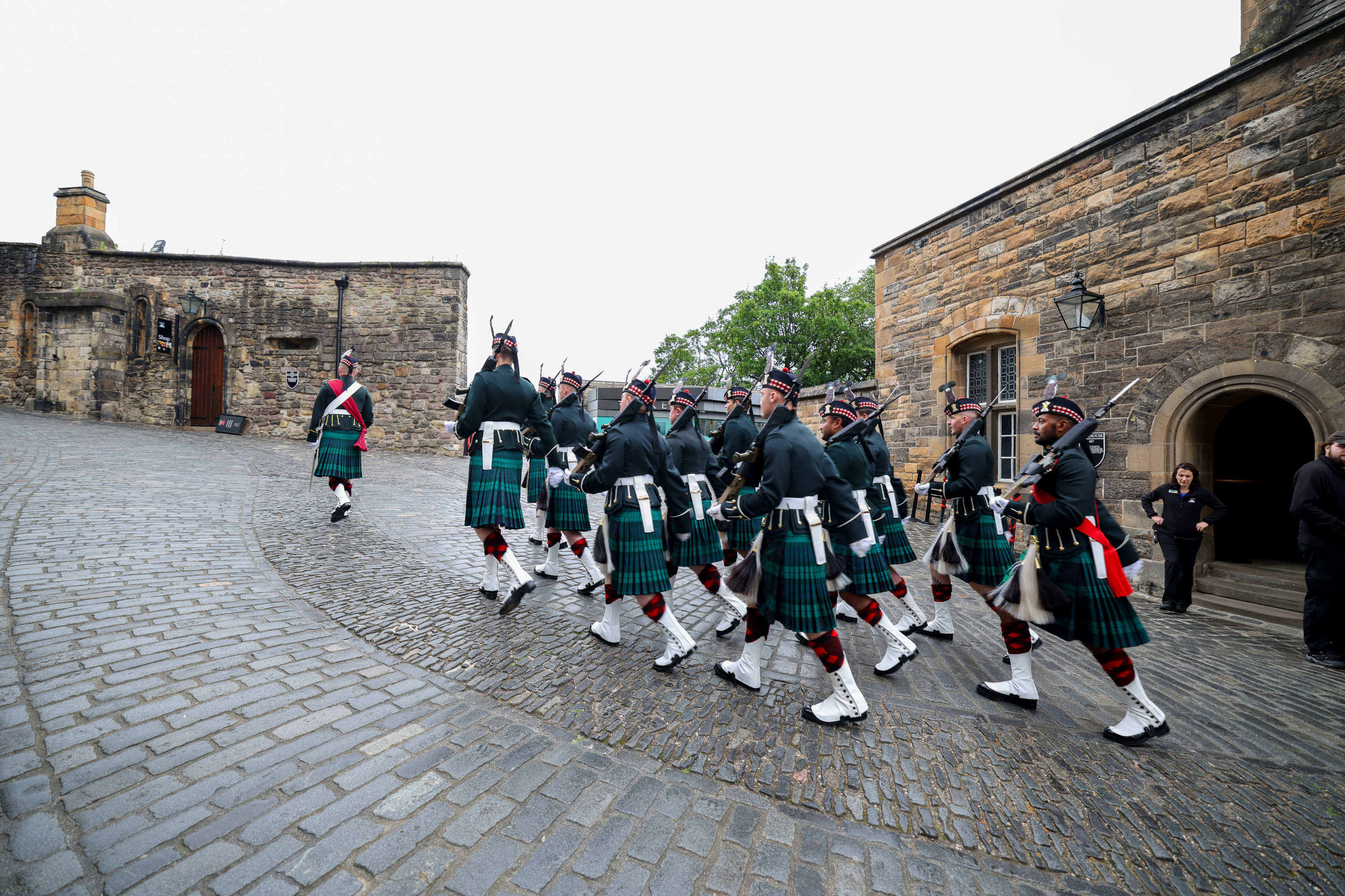A group of soldiers in Scottish ceremonial attire are pictured walking through Edinburgh. 