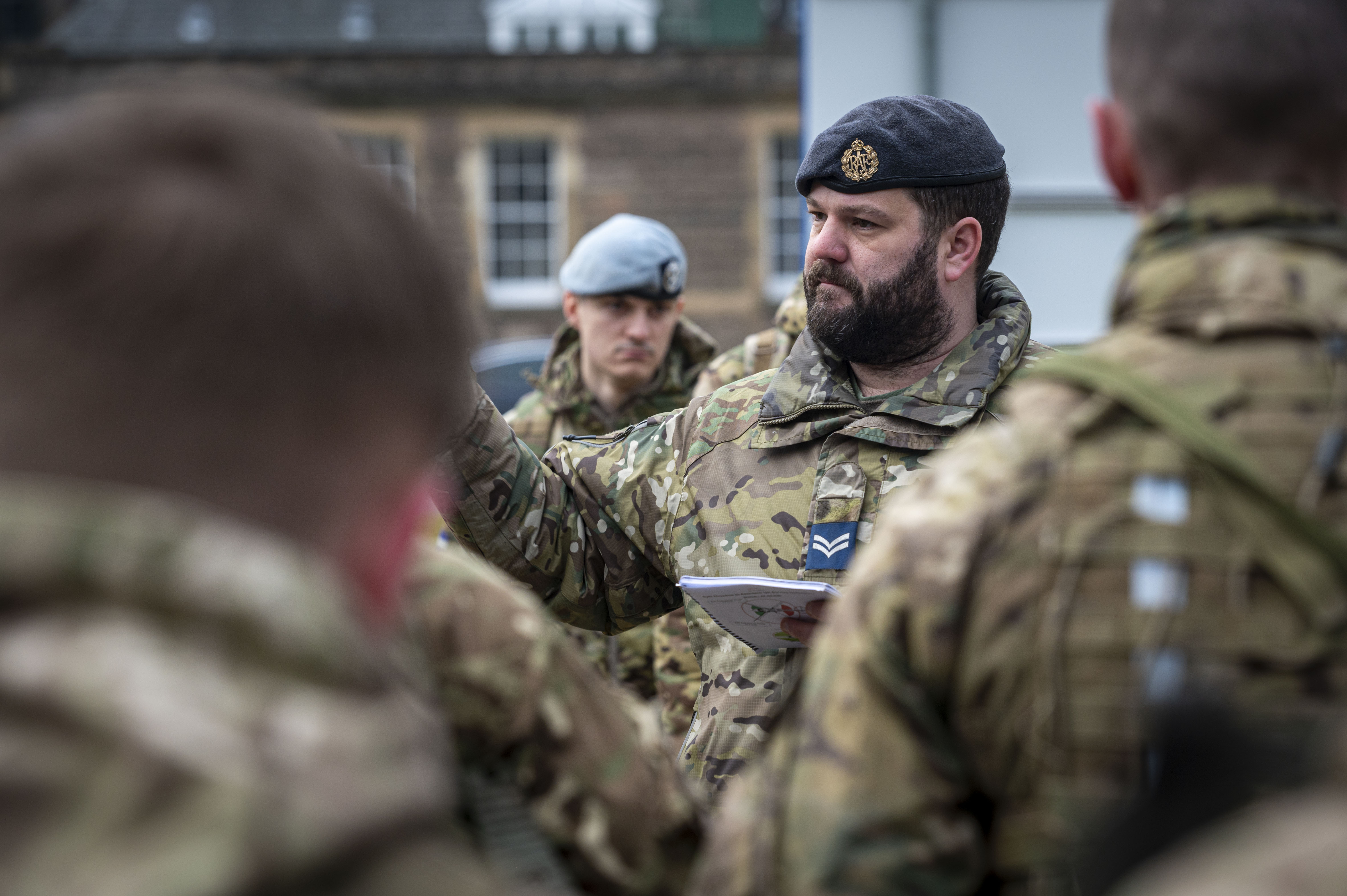 Soldiers in camouflage uniform are seen getting briefed before the ride in a Chinook. 
