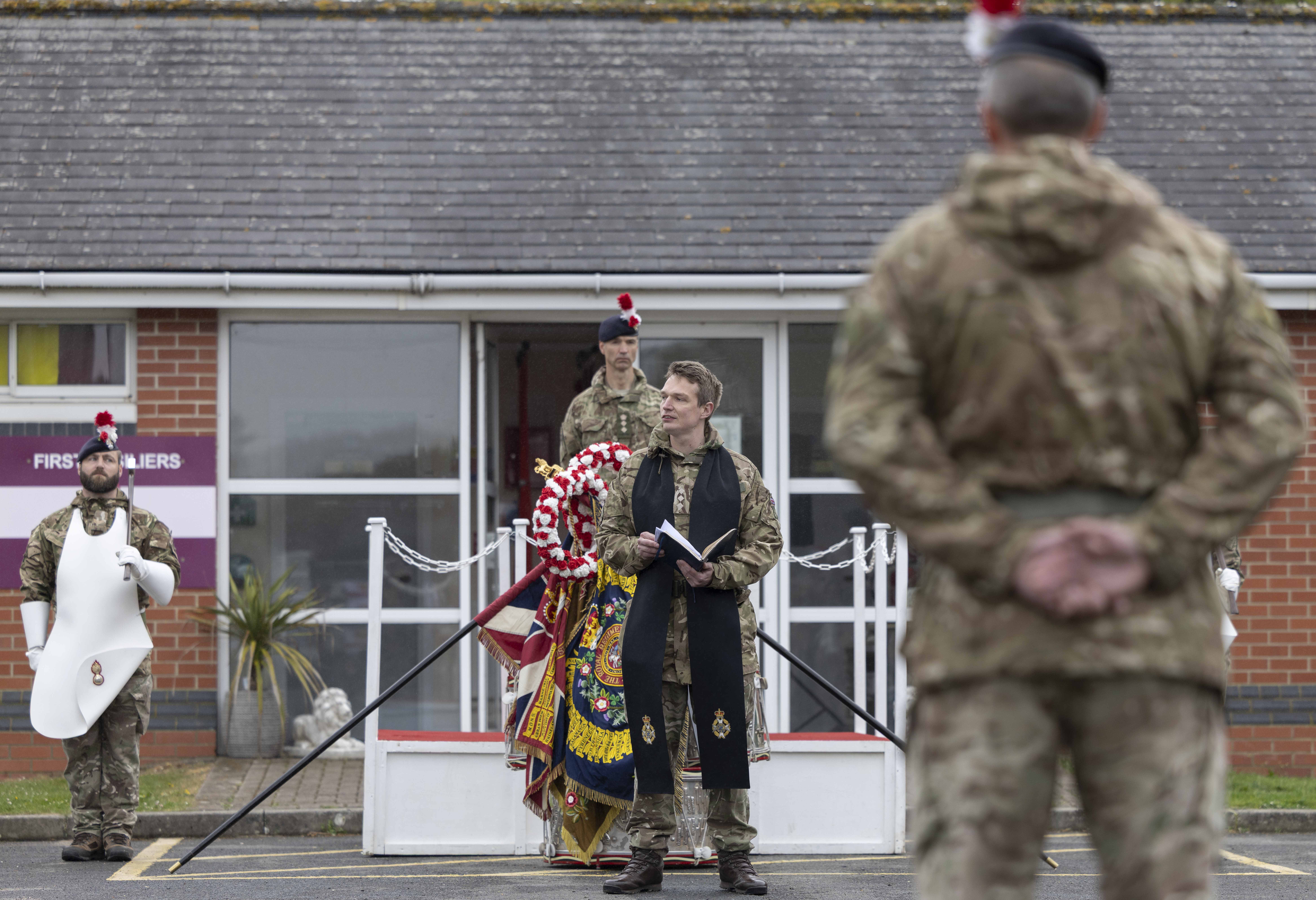 A Padre delivers a prayer on a parade.