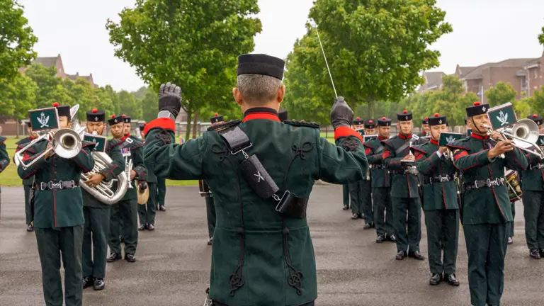 The Band of The Brigade of Gurkhas performing in their green ceremonial uniform at the AFC Harrogate Graduation Parade