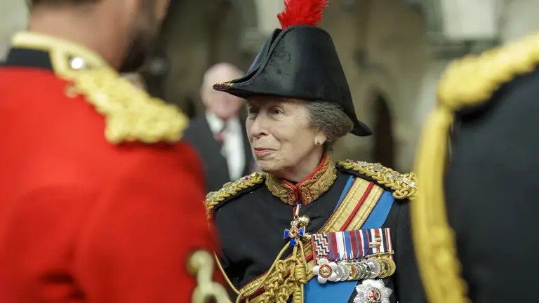 Her Royal Highness The Princess Royal wears black military ceremonial uniform while talking to members of the Army.