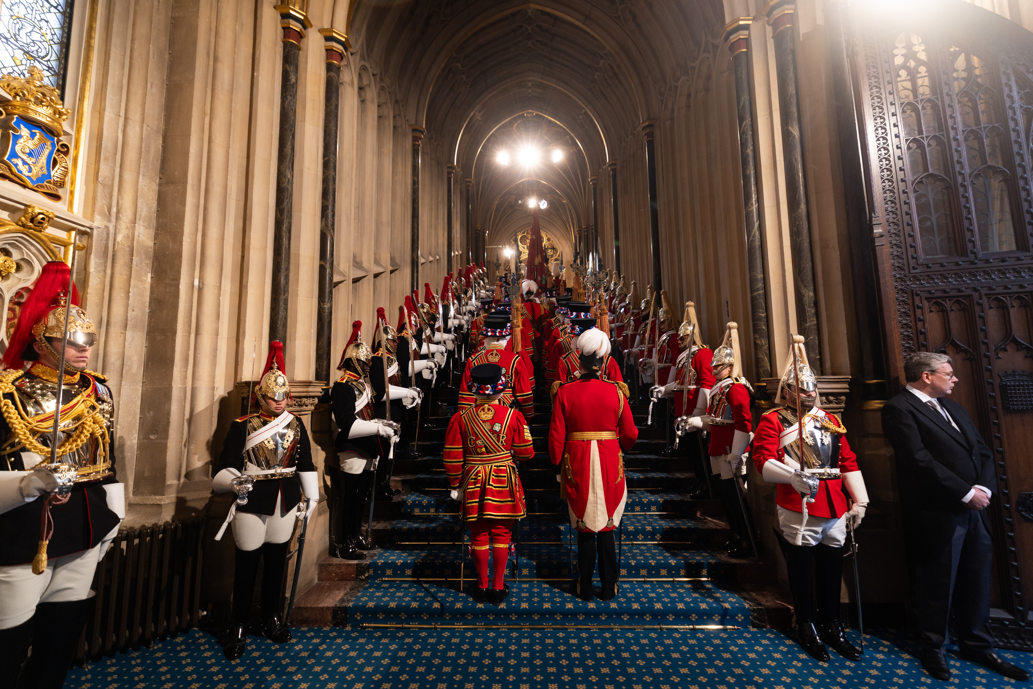 This image shows a ceremonial procession inside the entrance of Westminster Palace. 