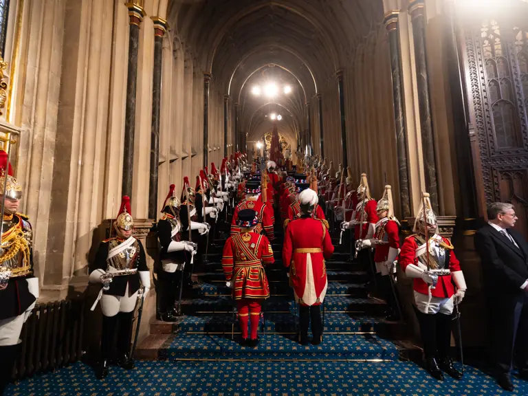This image shows a ceremonial procession inside the entrance of Westminster Palace.