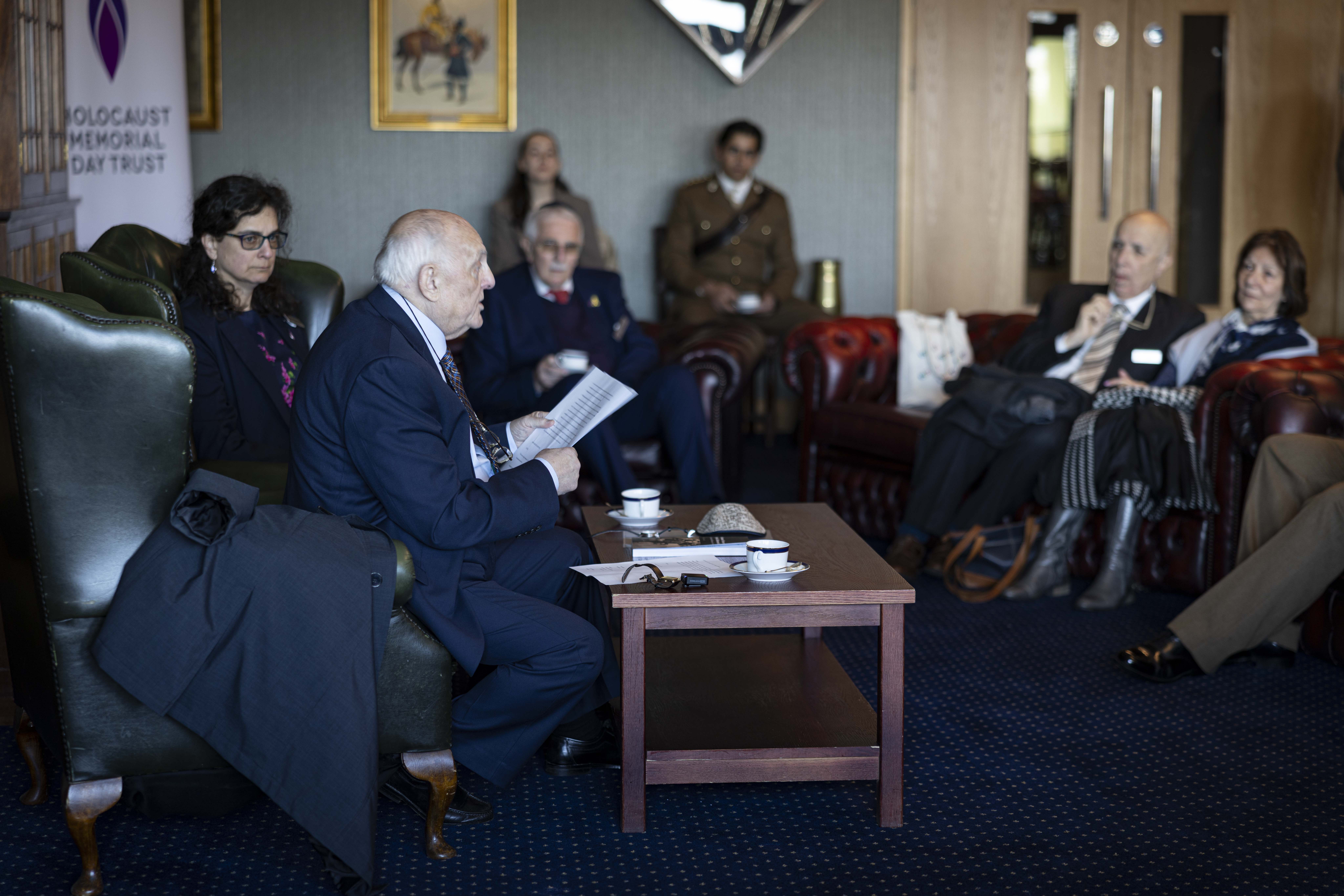 Dr Alfred Garwood is sat in a room with a military audience to gives a survivor talk after the ceremony.