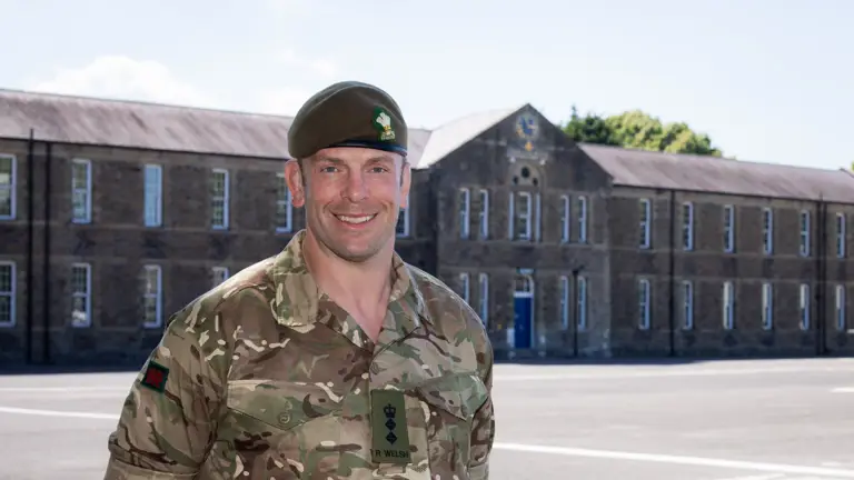 Alun Wyn Jones stands with his hands behind his back. He is wearing a camouflage uniform.