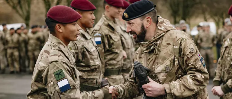 A signaller from the winning team of 216 (Para) Signals Squadron is awarded a trophy on the parade square.