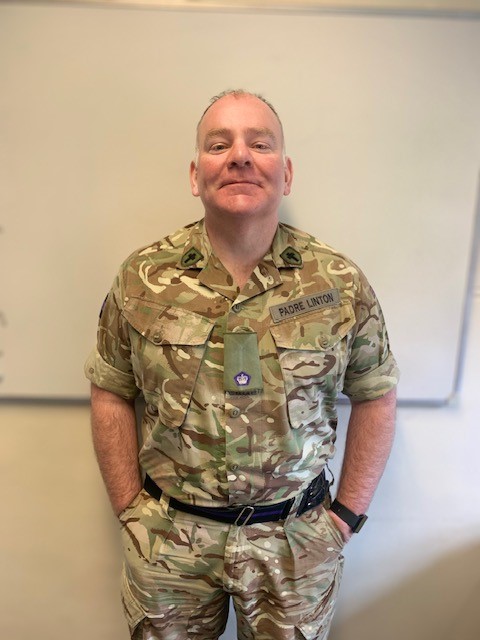 Reverend Ivan Linton posing for a portrait in his uniform. 