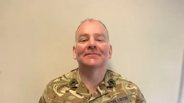 Reverend Ivan Linton posing for a portrait in his uniform.