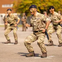Soldiers in uniform are pictured with a Nepali ceremonial knife.