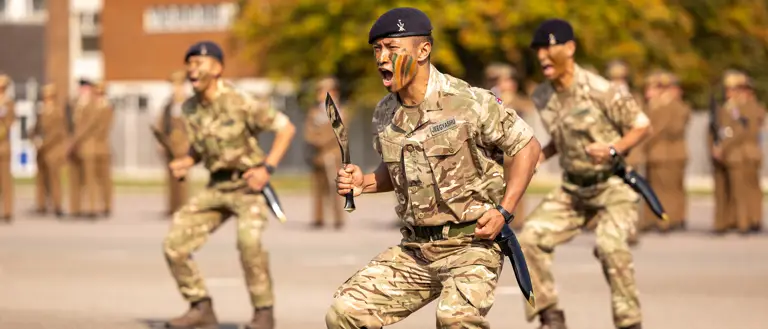 Soldiers in uniform are pictured with a Nepali ceremonial knife.